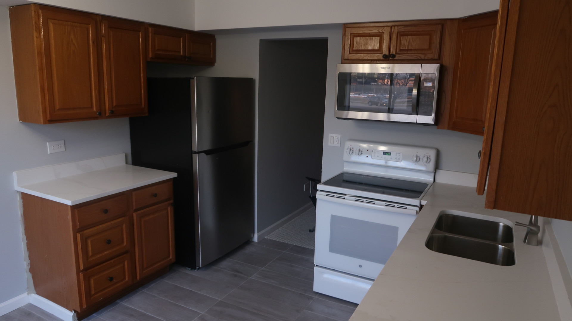 5500 Tinder, Unit 2 Rolling Meadows, IL 60008 - Photo 4 of 14 a kitchen with a refrigerator stove and cabinets