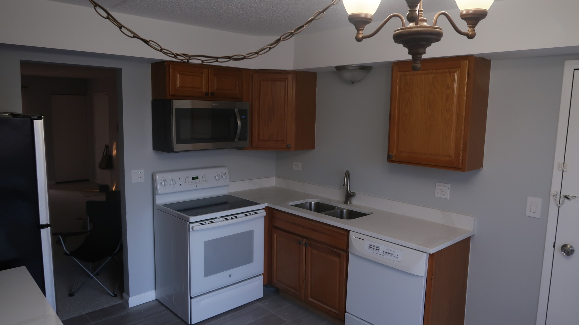 5500 Tinder, Unit 2 Rolling Meadows, IL 60008 - Photo 5 of 14 a kitchen with stainless steel appliances a stove a microwave and a sink