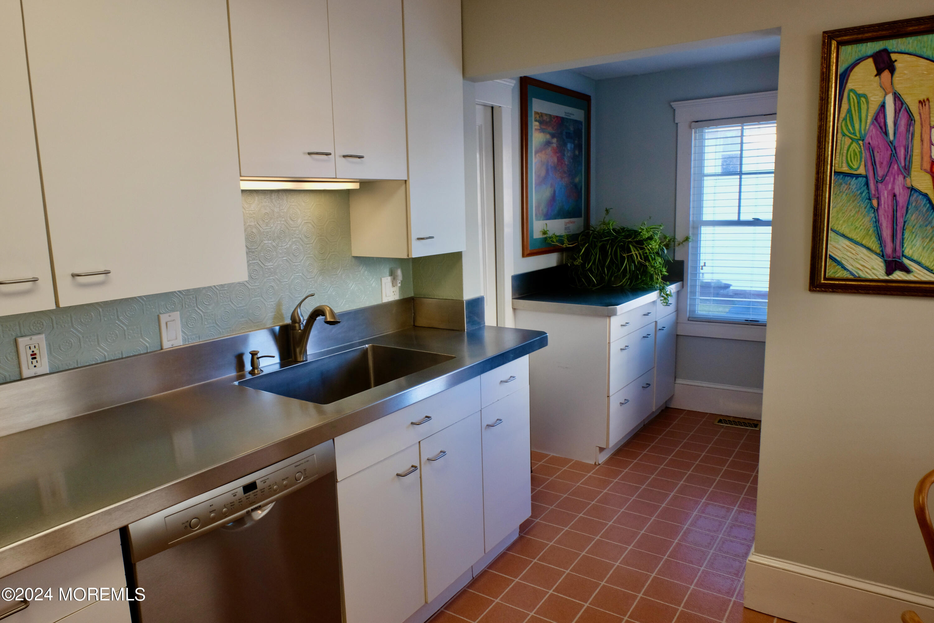 220 Lincoln Avenue, Unit 1 Avon-by-the-Sea, NJ 07717 - Photo 11 of 26 a kitchen with stainless steel appliances a sink a stove and cabinets