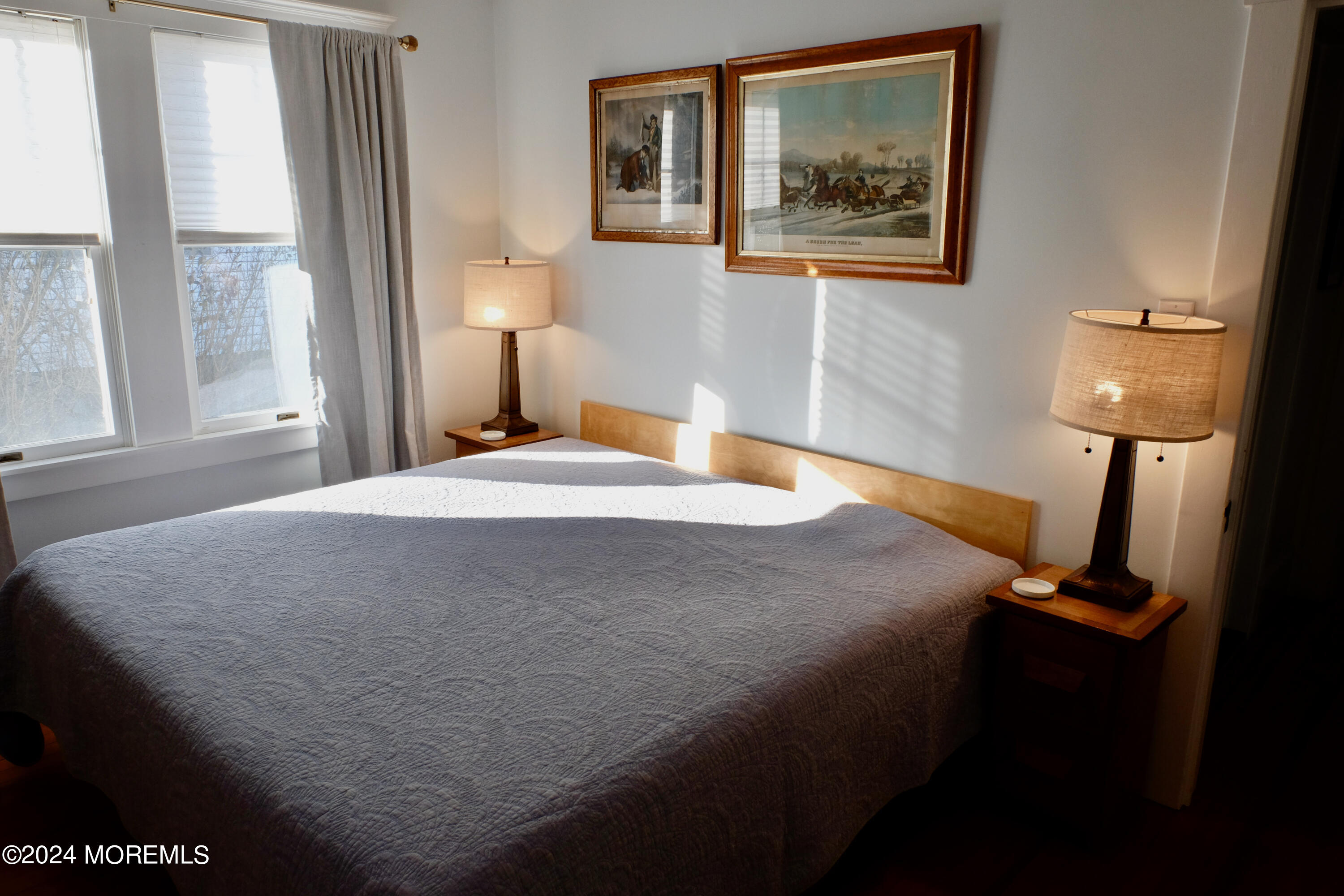 220 Lincoln Avenue, Unit 1 Avon-by-the-Sea, NJ 07717 - Photo 15 of 26 a bedroom with a bed and wooden floor