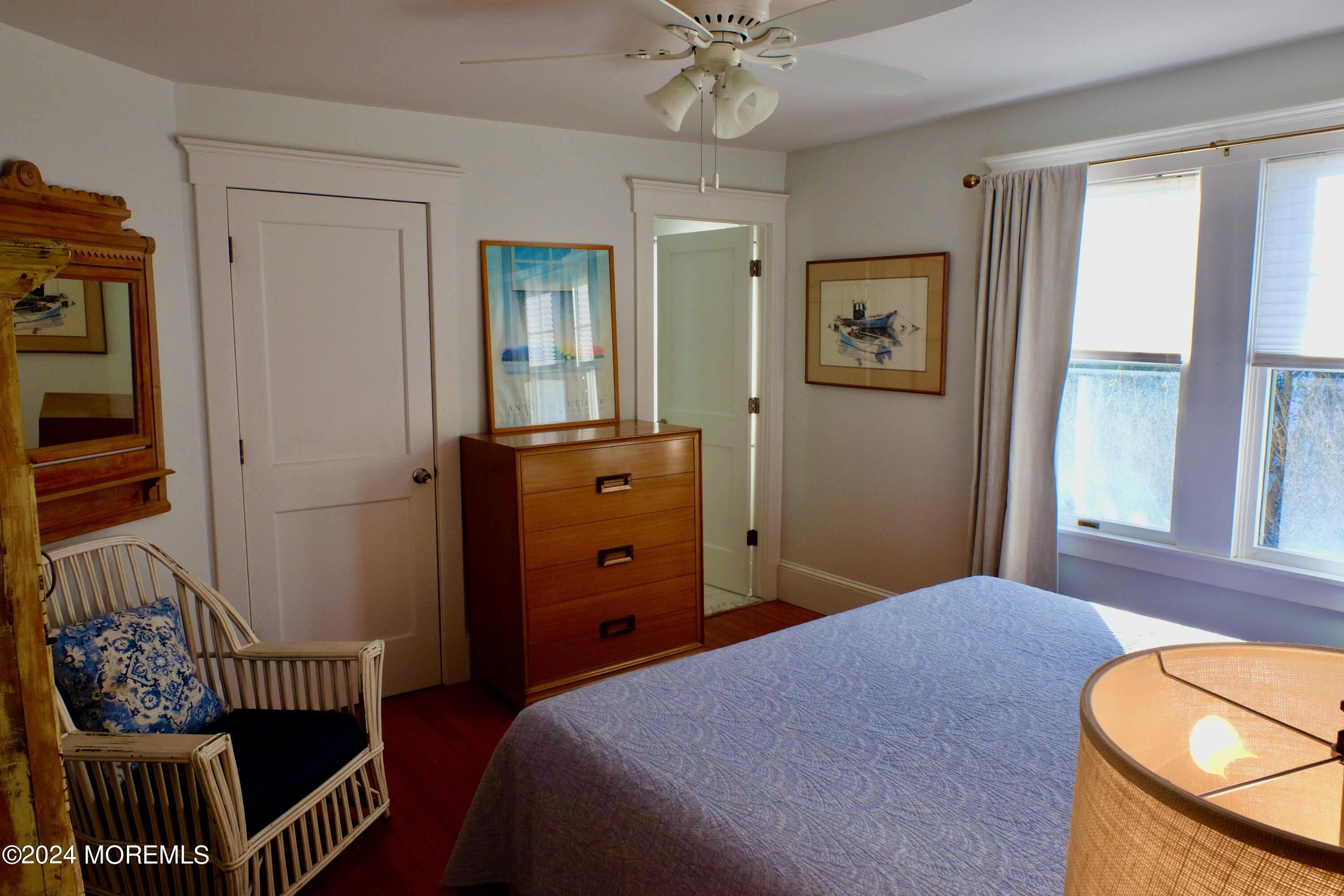 220 Lincoln Avenue, Unit 1 Avon-by-the-Sea, NJ 07717 - Photo 16 of 26 a bedroom with a bed and a chandelier