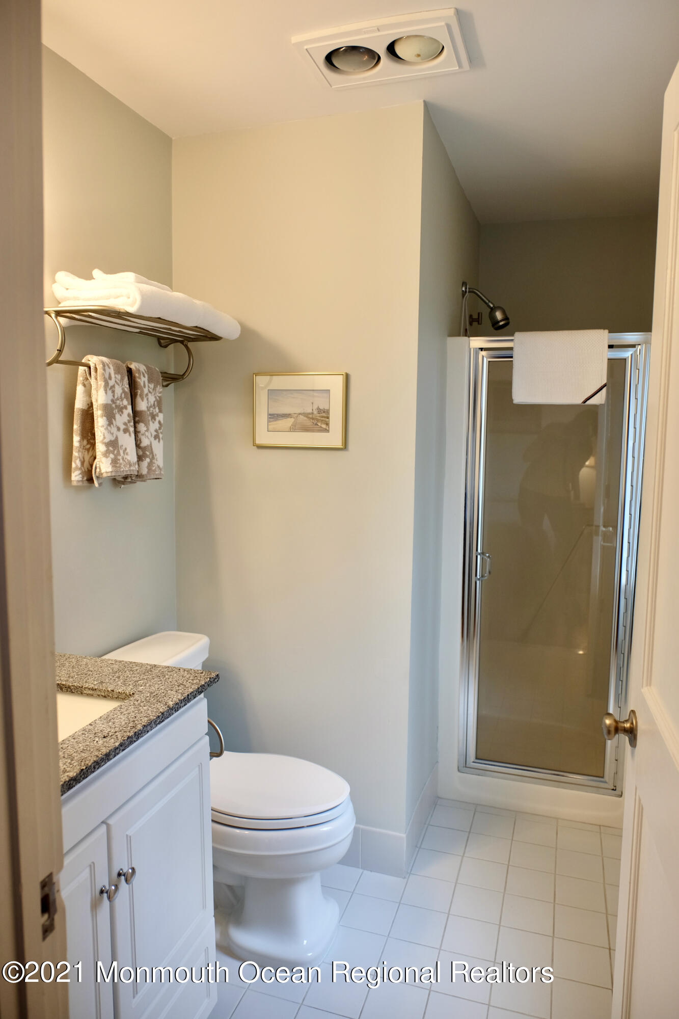 220 Lincoln Avenue, Unit 1 Avon-by-the-Sea, NJ 07717 - Photo 17 of 26 a bathroom with a granite countertop toilet a sink and shower