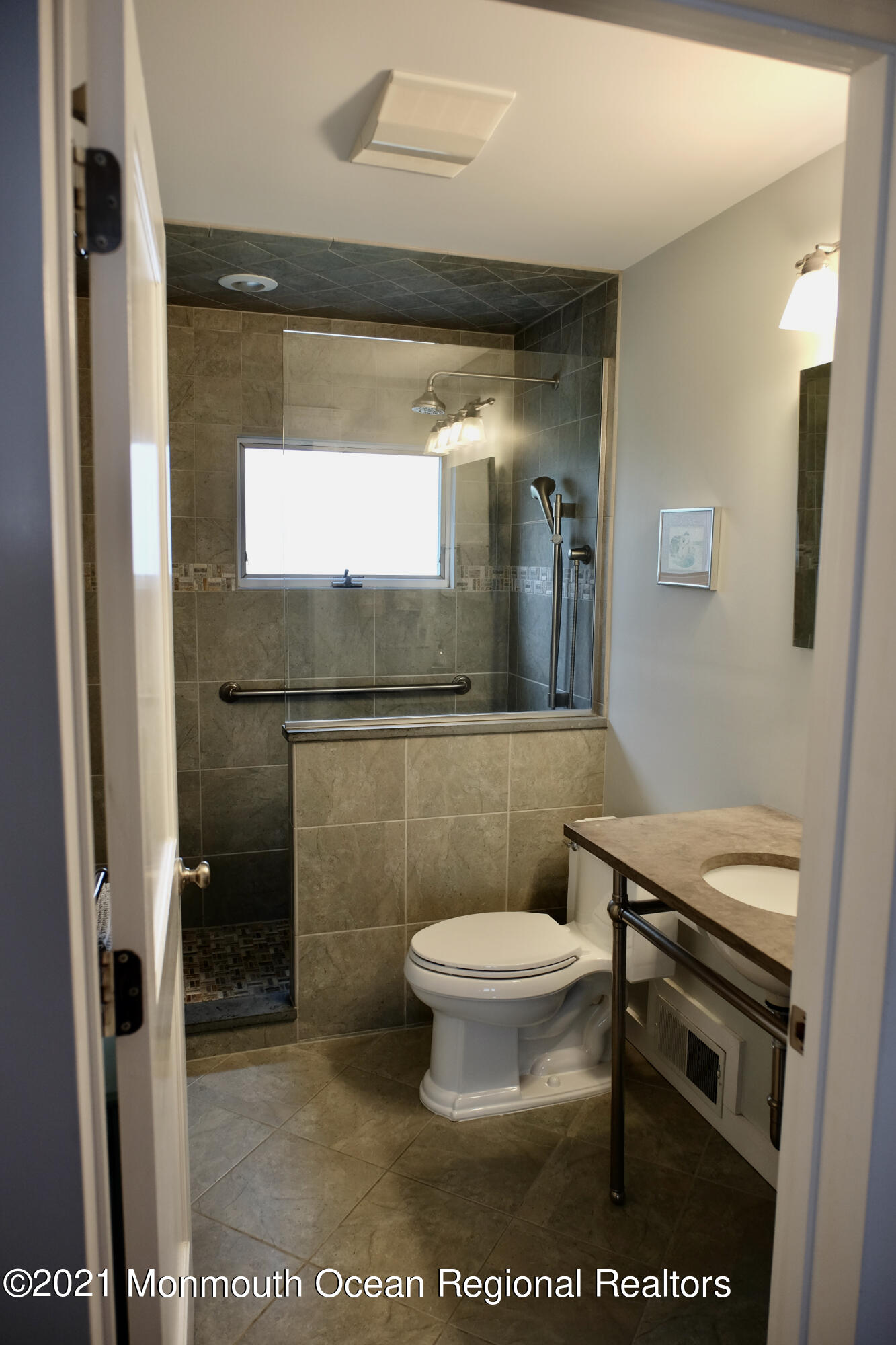 220 Lincoln Avenue, Unit 1 Avon-by-the-Sea, NJ 07717 - Photo 20 of 26 a bathroom with a toilet a sink and mirror