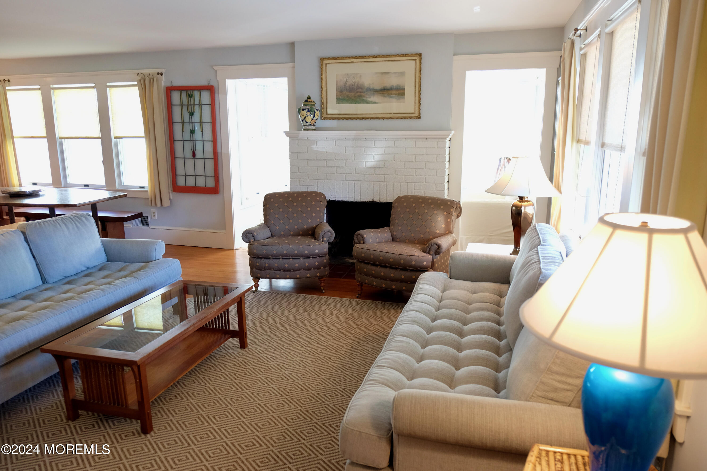 220 Lincoln Avenue, Unit 1 Avon-by-the-Sea, NJ 07717 - Photo 2 of 26 a living room with furniture and a fireplace