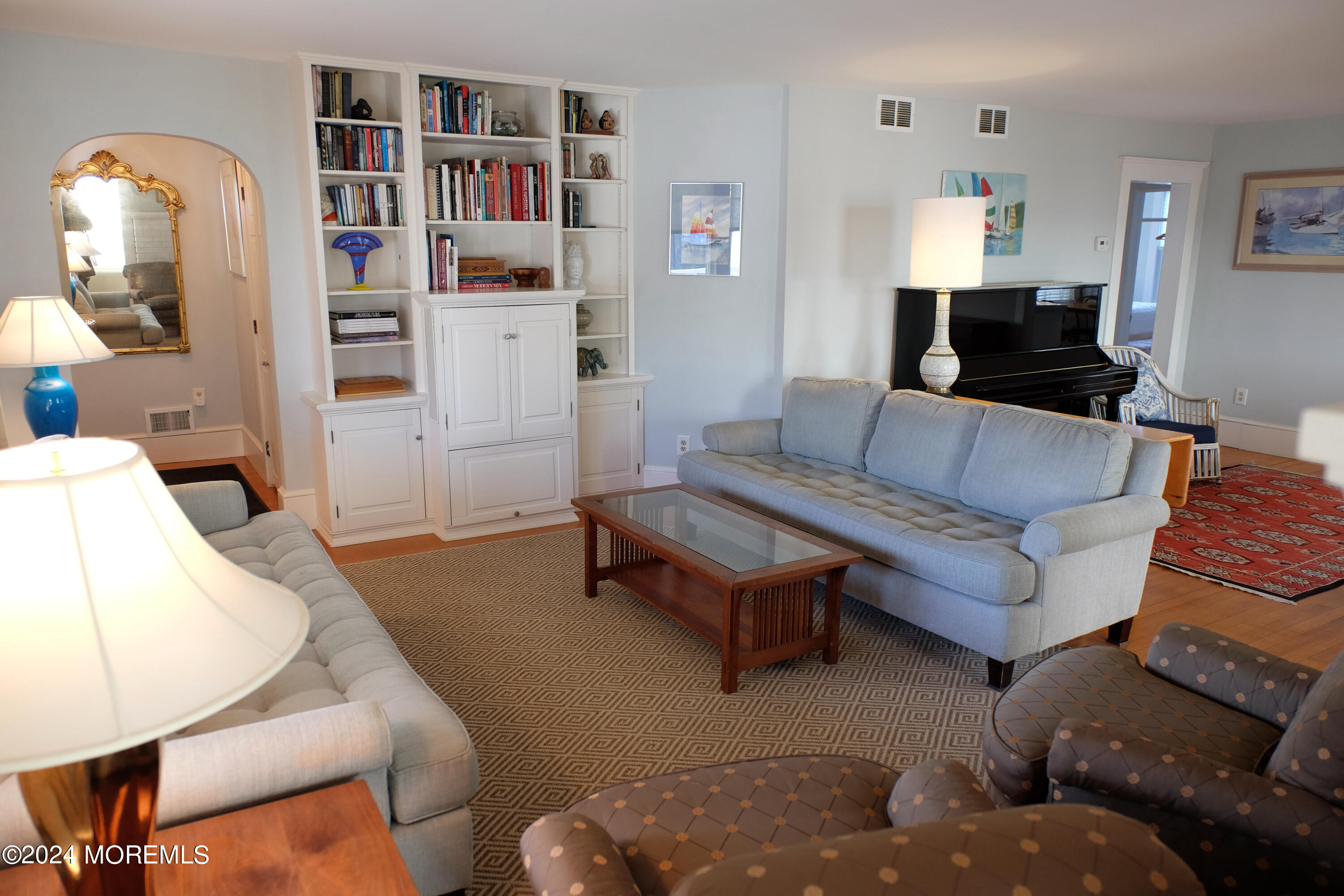 220 Lincoln Avenue, Unit 1 Avon-by-the-Sea, NJ 07717 - Photo 4 of 26 a living room with furniture and a book shelf
