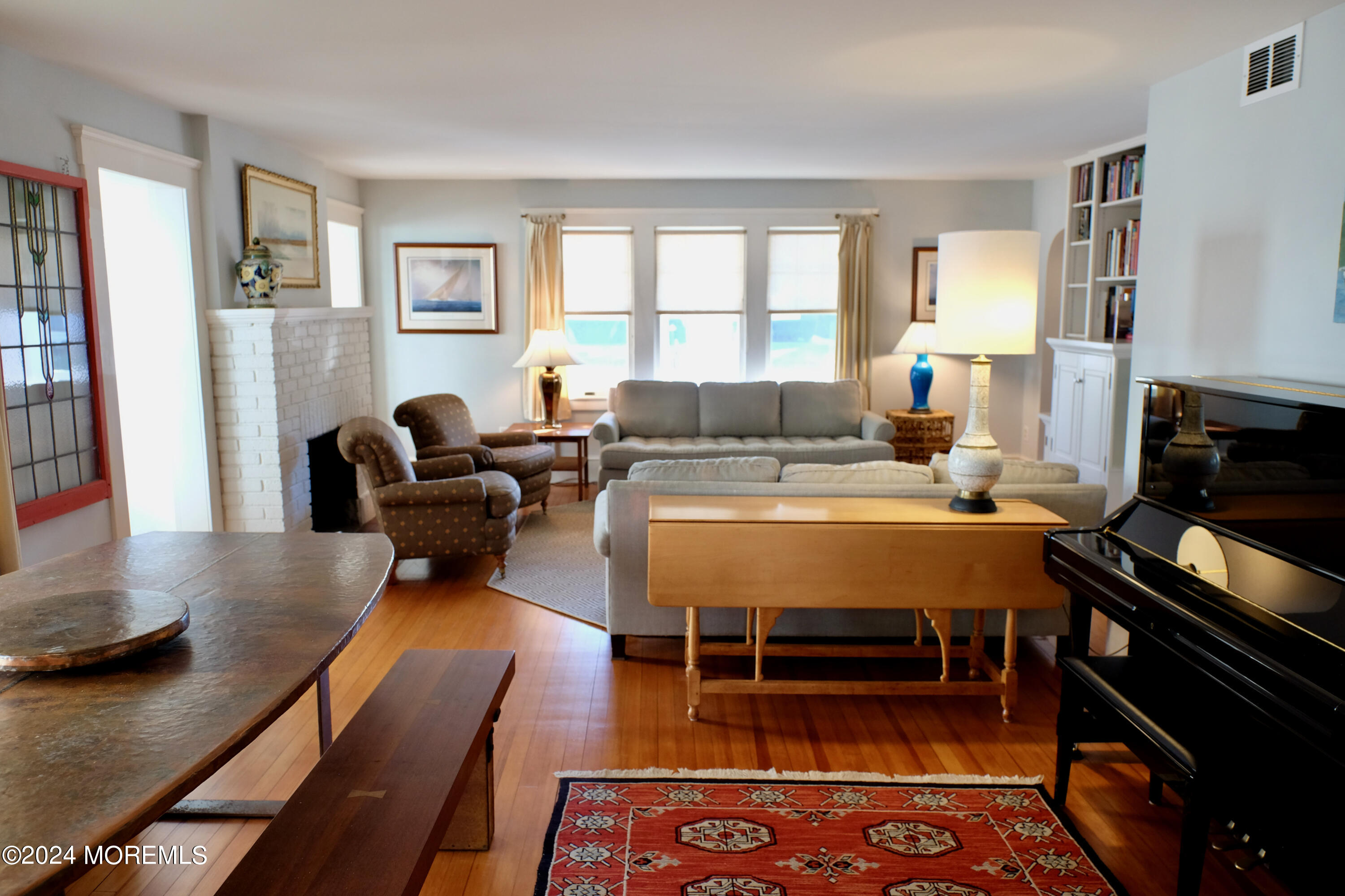 220 Lincoln Avenue, Unit 1 Avon-by-the-Sea, NJ 07717 - Photo 5 of 26 a living room with furniture fireplace and a window