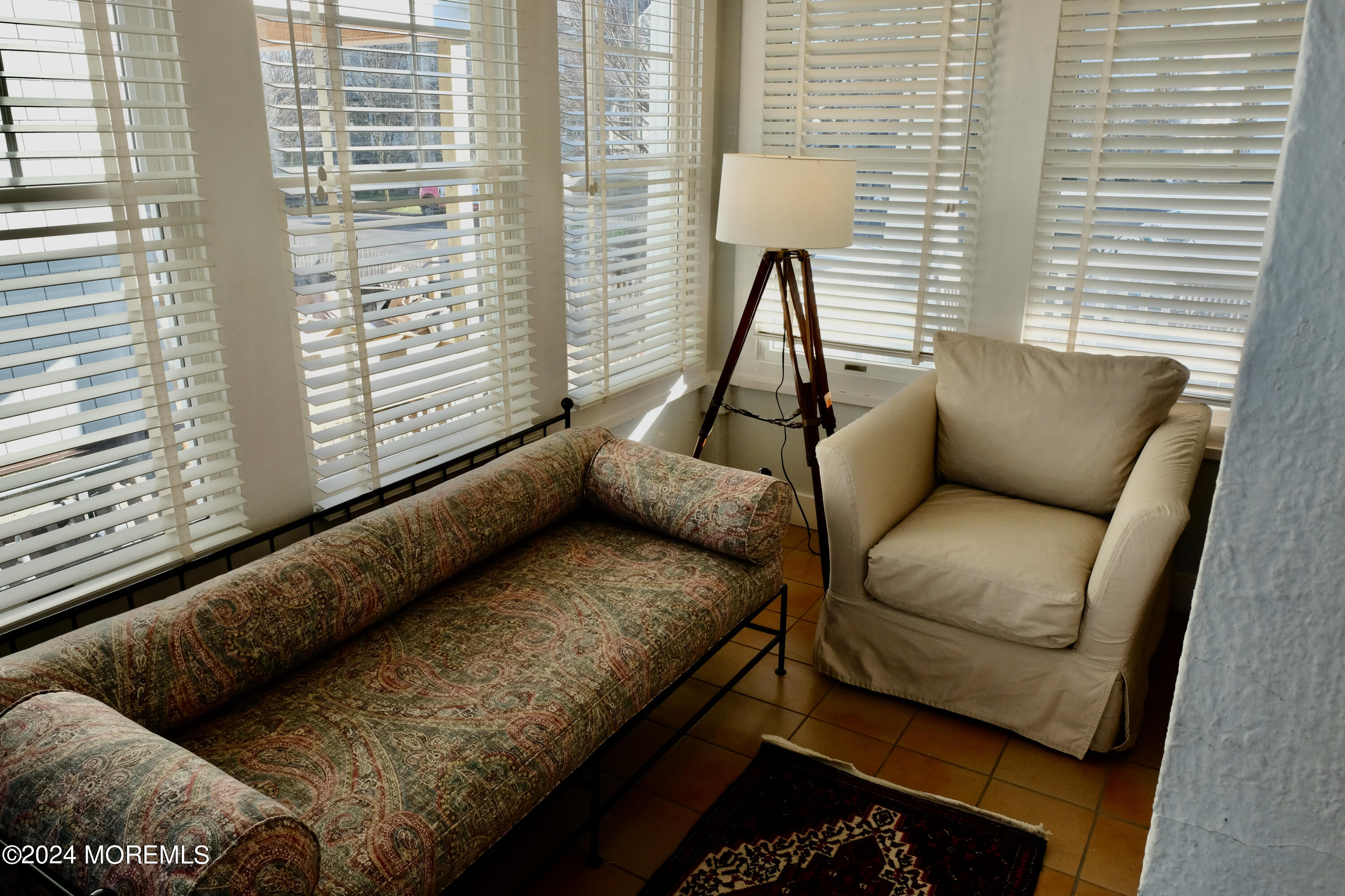 220 Lincoln Avenue, Unit 1 Avon-by-the-Sea, NJ 07717 - Photo 9 of 26 a living room with furniture and a large window