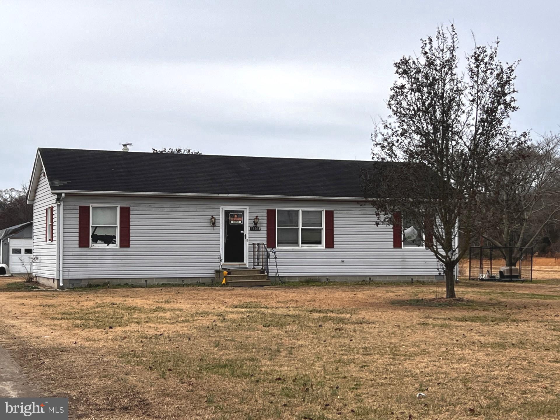 a house that has a tree in front of it