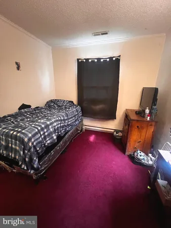 a bedroom with a bed and a television in it
