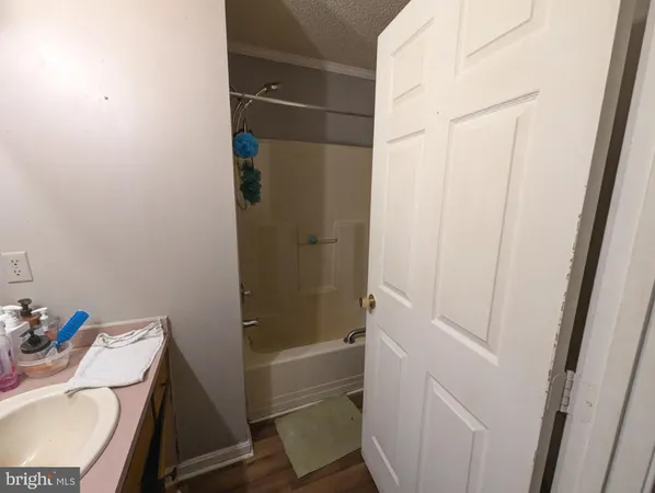 a room with water heater and wooden cabinets