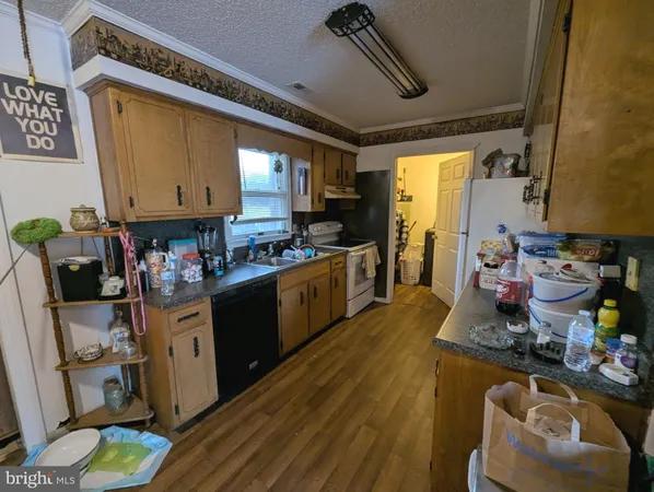 a kitchen with stainless steel appliances kitchen island granite countertop a stove and white cabinets