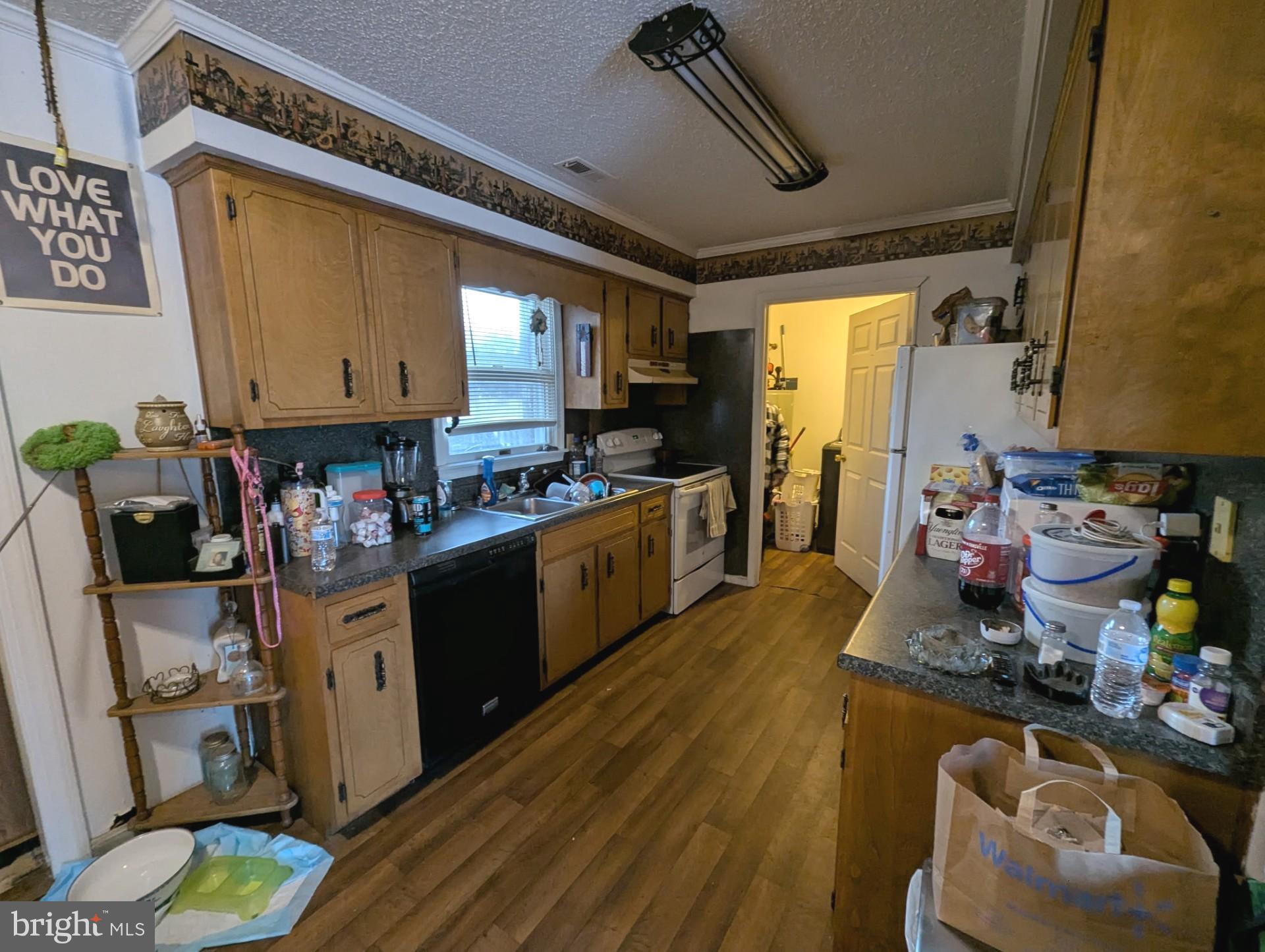 26581 Siloam Road Salisbury, MD 21801 - Photo 6 of 24 a kitchen with stainless steel appliances kitchen island granite countertop a stove and white cabinets