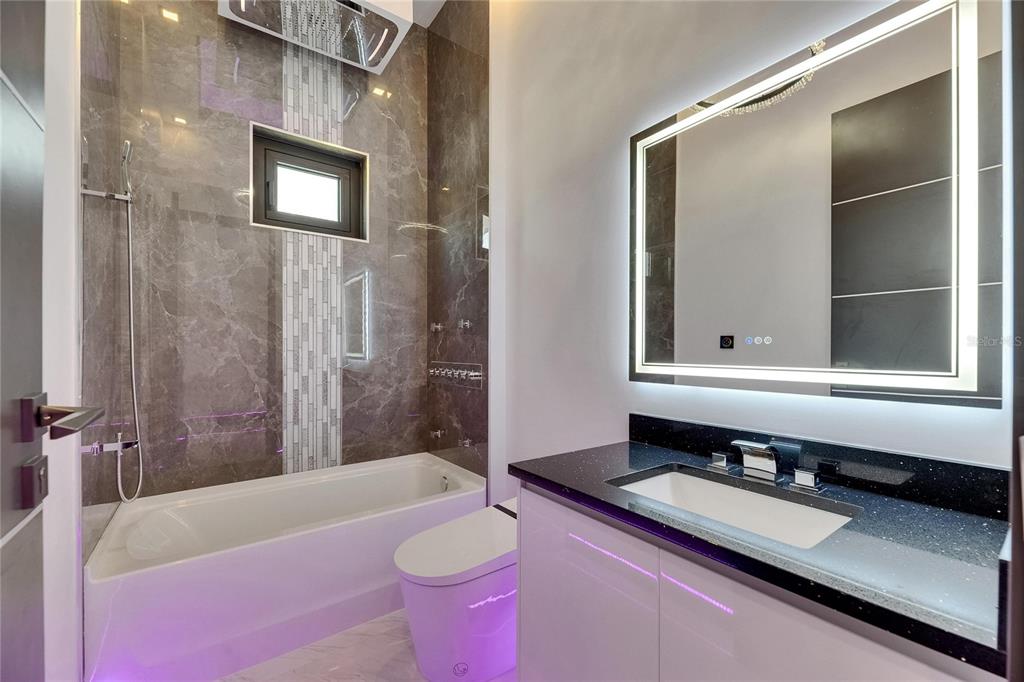 6532 Simone Shores Circle Apollo Beach, FL 33572 - Photo 11 of 86 a bathroom with a granite countertop tub sink and mirror