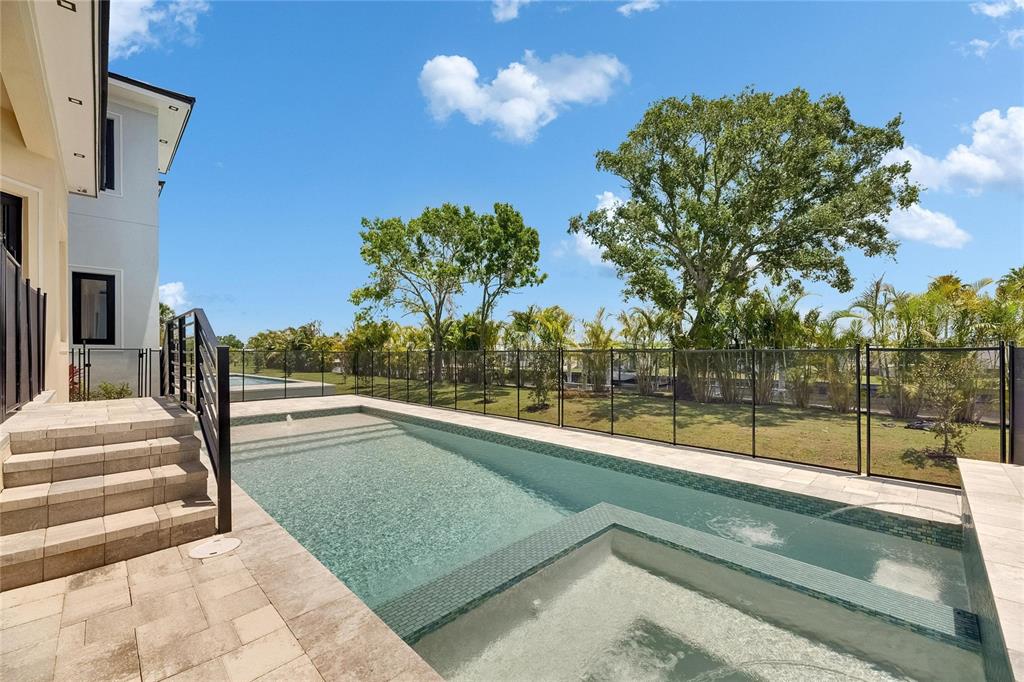 6532 Simone Shores Circle Apollo Beach, FL 33572 - Photo 59 of 86 a view of a swimming pool with a patio and a yard