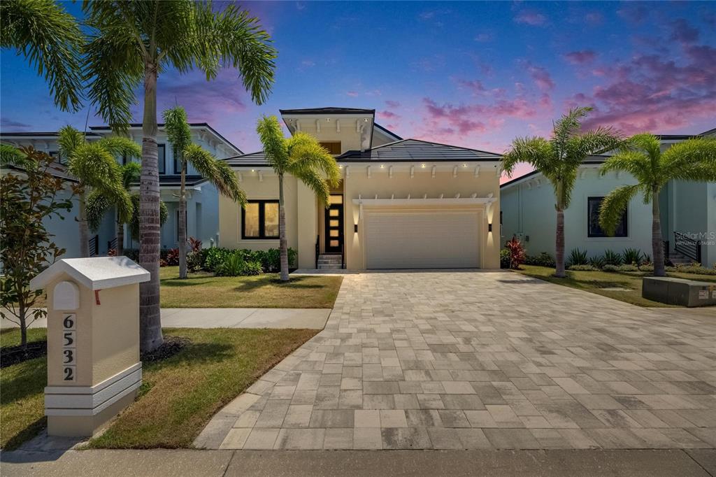 6532 Simone Shores Circle Apollo Beach, FL 33572 - Photo 67 of 86 a view of a white house with a yard and potted plants