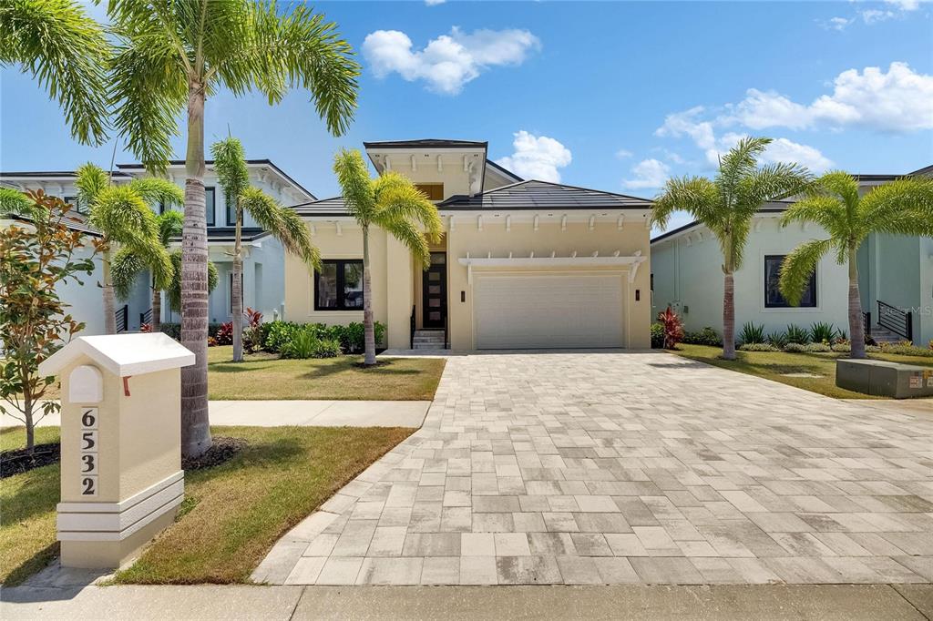6532 Simone Shores Circle Apollo Beach, FL 33572 - Photo 69 of 86 a view of a white house with a yard and palm trees