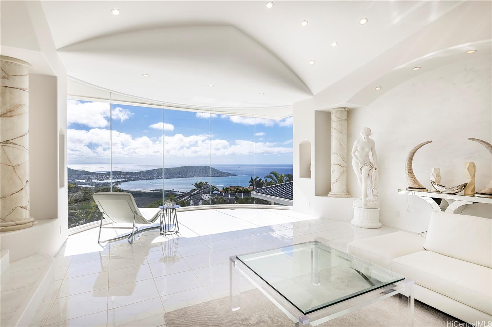 a dining hall with couches and view of living room