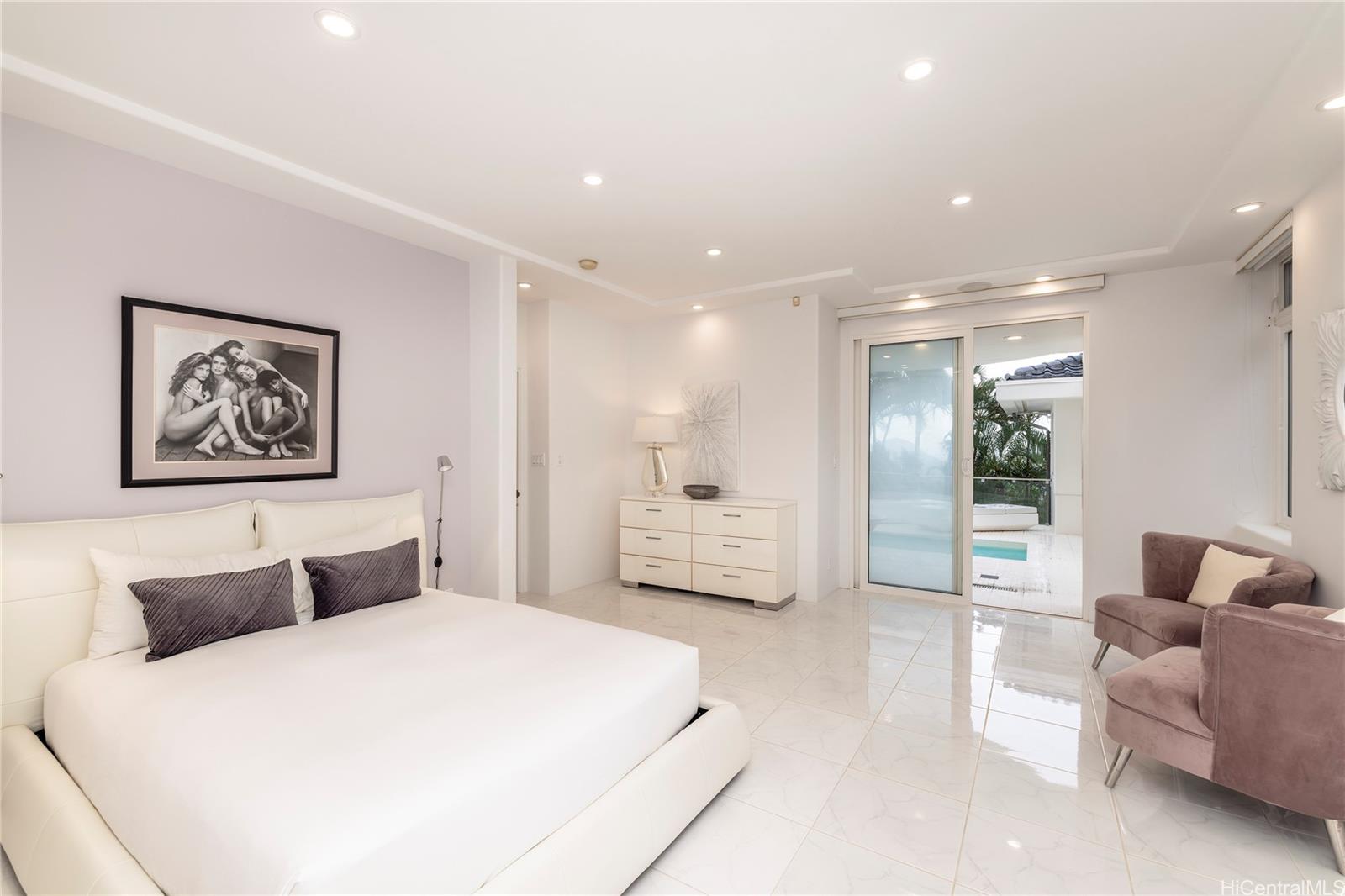 875 Ikena Circle Honolulu, HI 96821 - Photo 14 of 22 a bedroom with a large bed and a couch