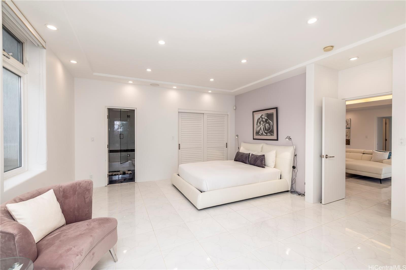 875 Ikena Circle Honolulu, HI 96821 - Photo 15 of 22 a spacious bedroom with a bed and furniture