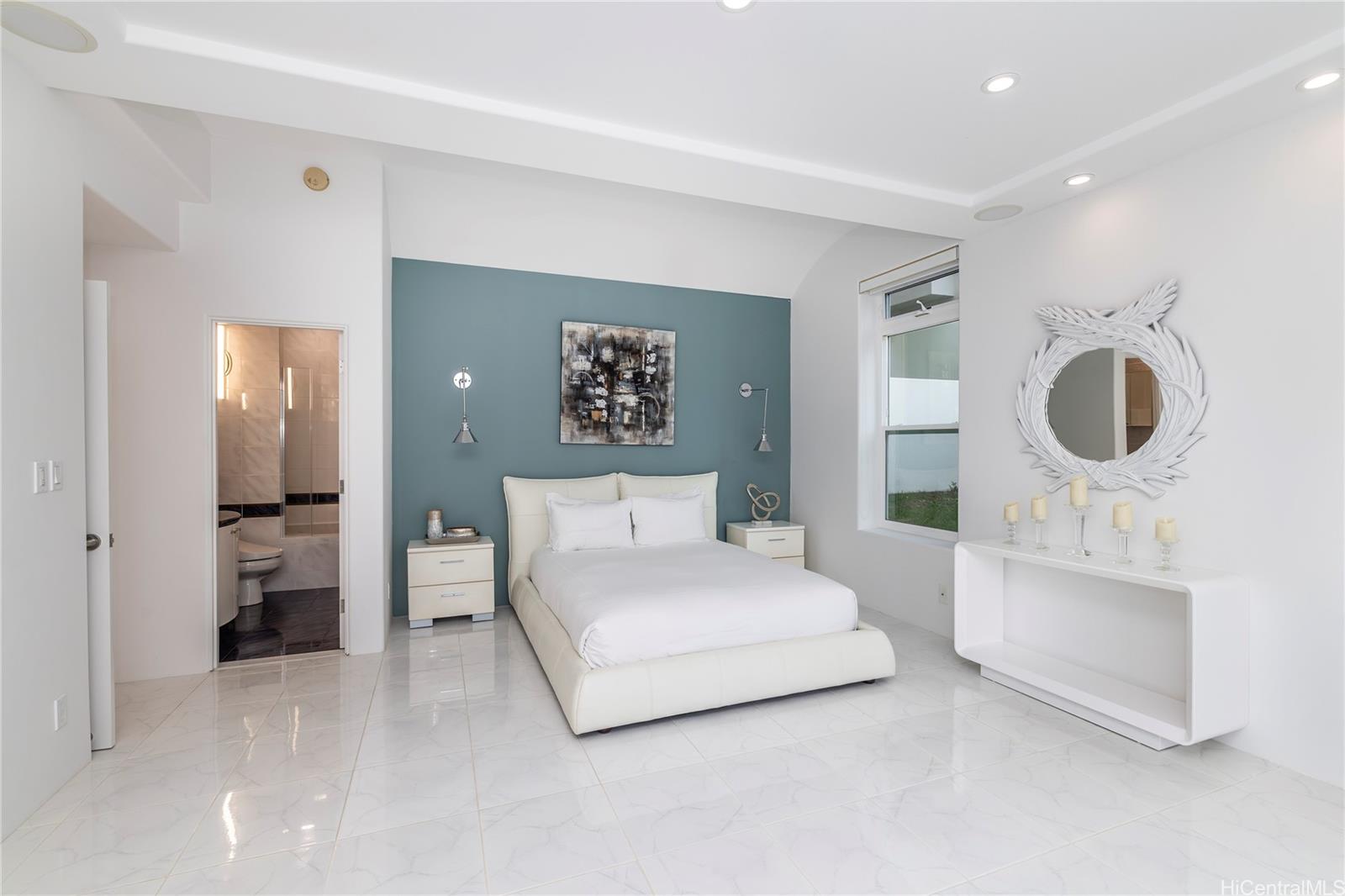 875 Ikena Circle Honolulu, HI 96821 - Photo 16 of 22 a spacious bedroom with a bed and cabinets