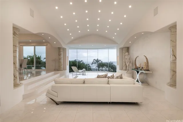 a living room with furniture and a potted plant