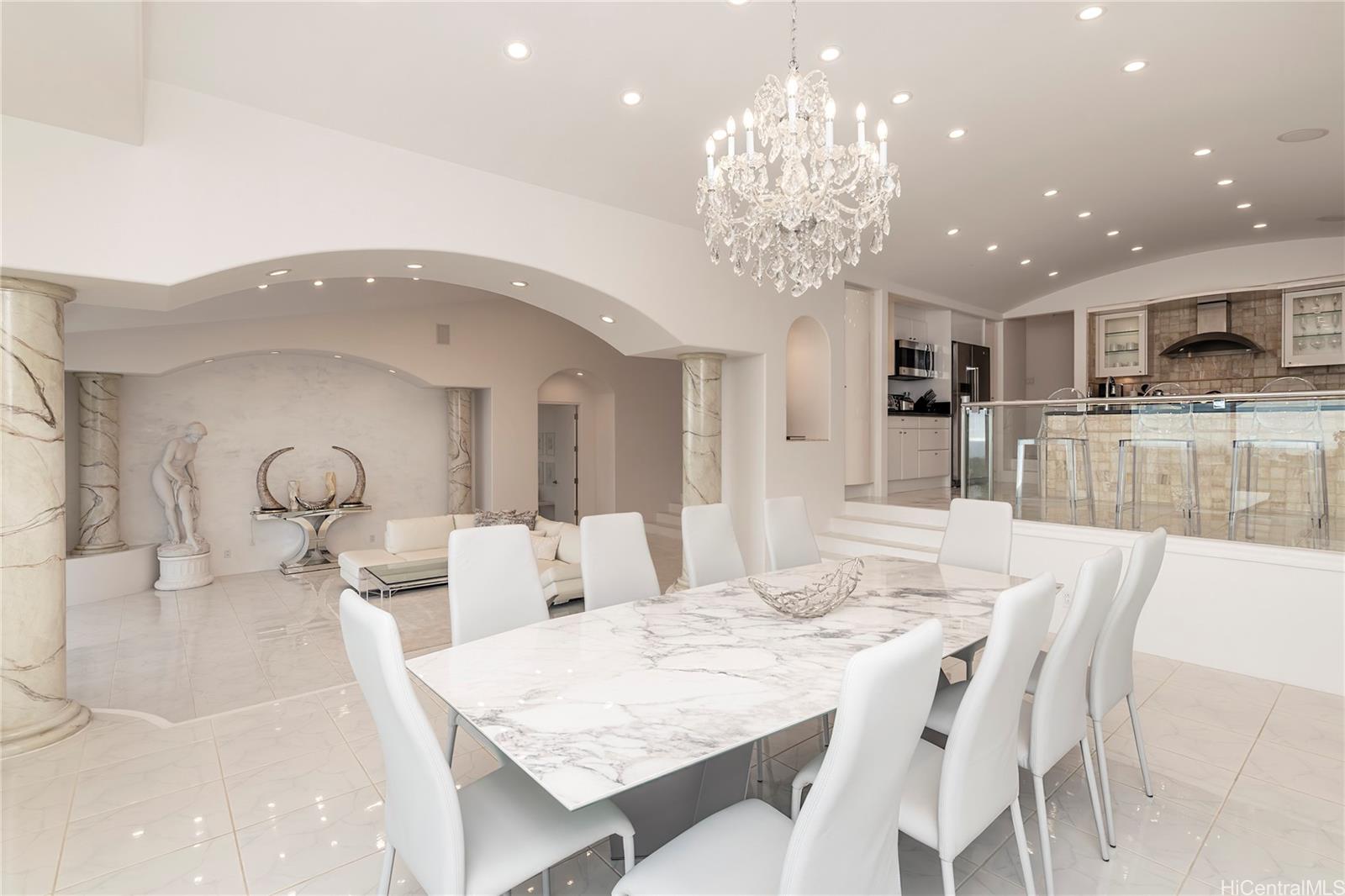 875 Ikena Circle Honolulu, HI 96821 - Photo 4 of 22 a large kitchen with granite countertop a table and chairs in it