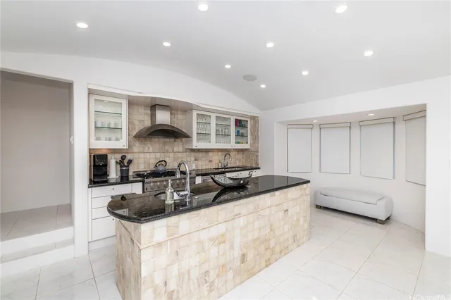 a kitchen with stainless steel appliances granite countertop a sink a stove and a refrigerator