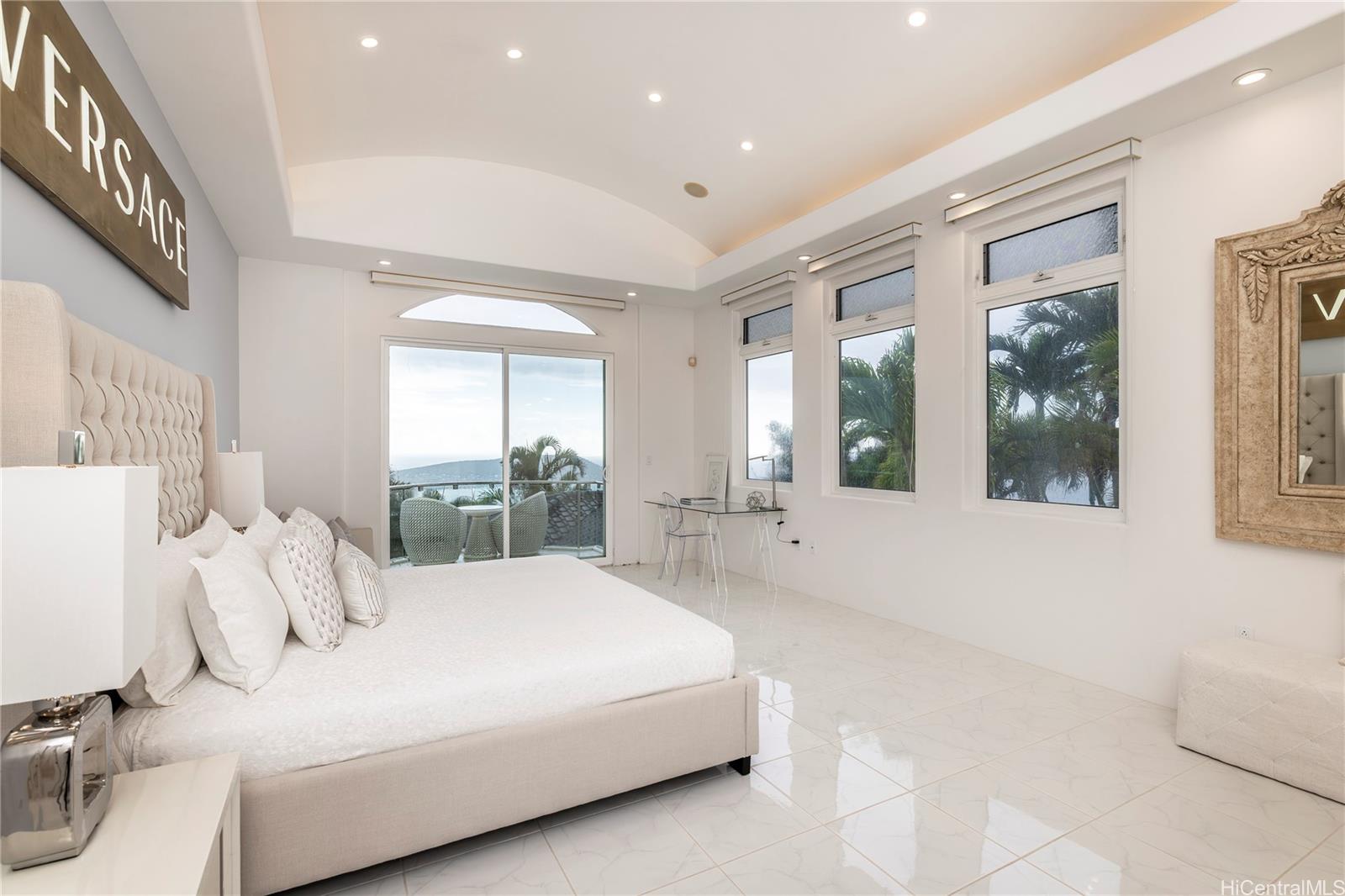 875 Ikena Circle Honolulu, HI 96821 - Photo 7 of 22 a large bedroom with a large bed and a large window