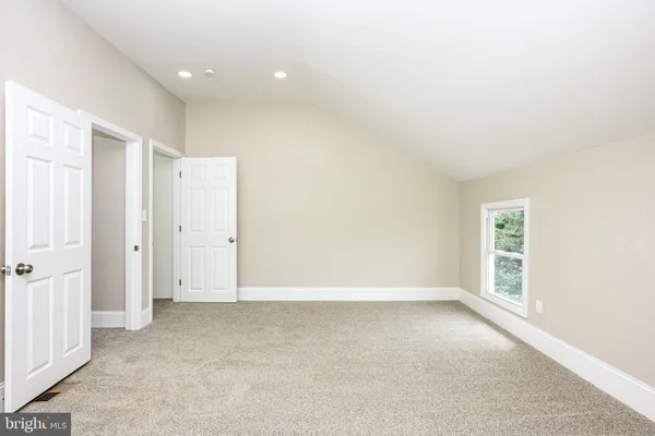 an empty room with windows and closet