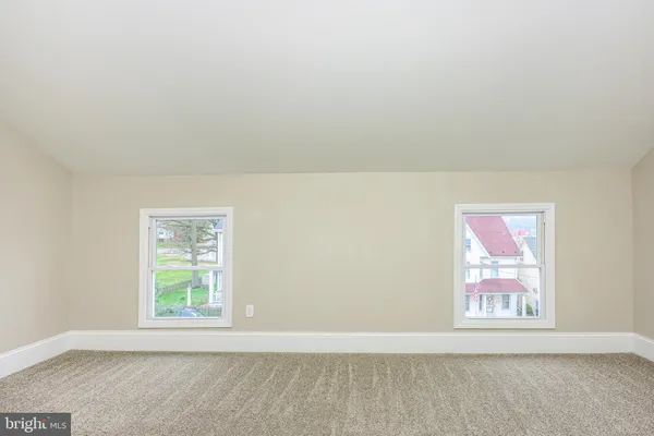 a view of an empty room and a window