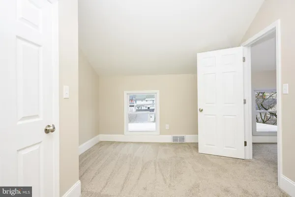 a view of a room with wooden shelves