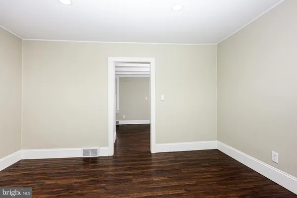 a view of a hallway with wooden floor and a fireplace