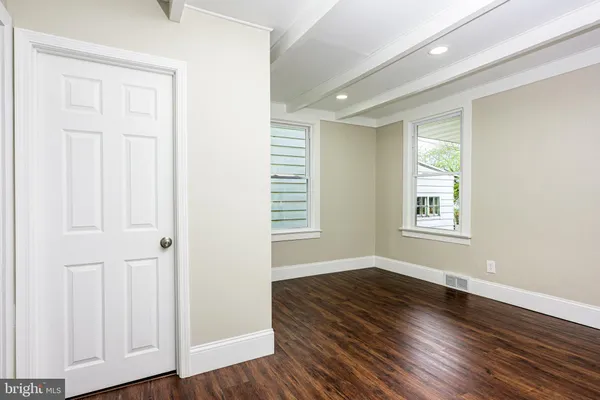 a white toilet sitting next to a white sink and vanity