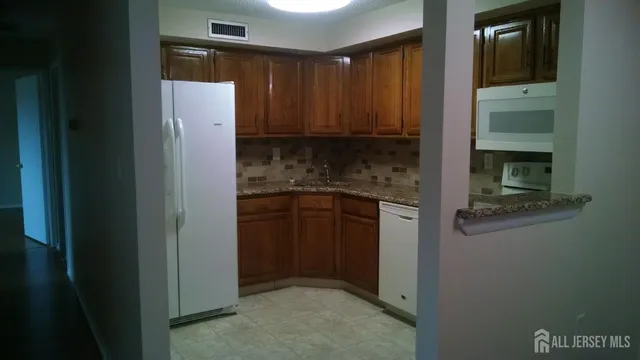 a kitchen with a refrigerator and cabinets