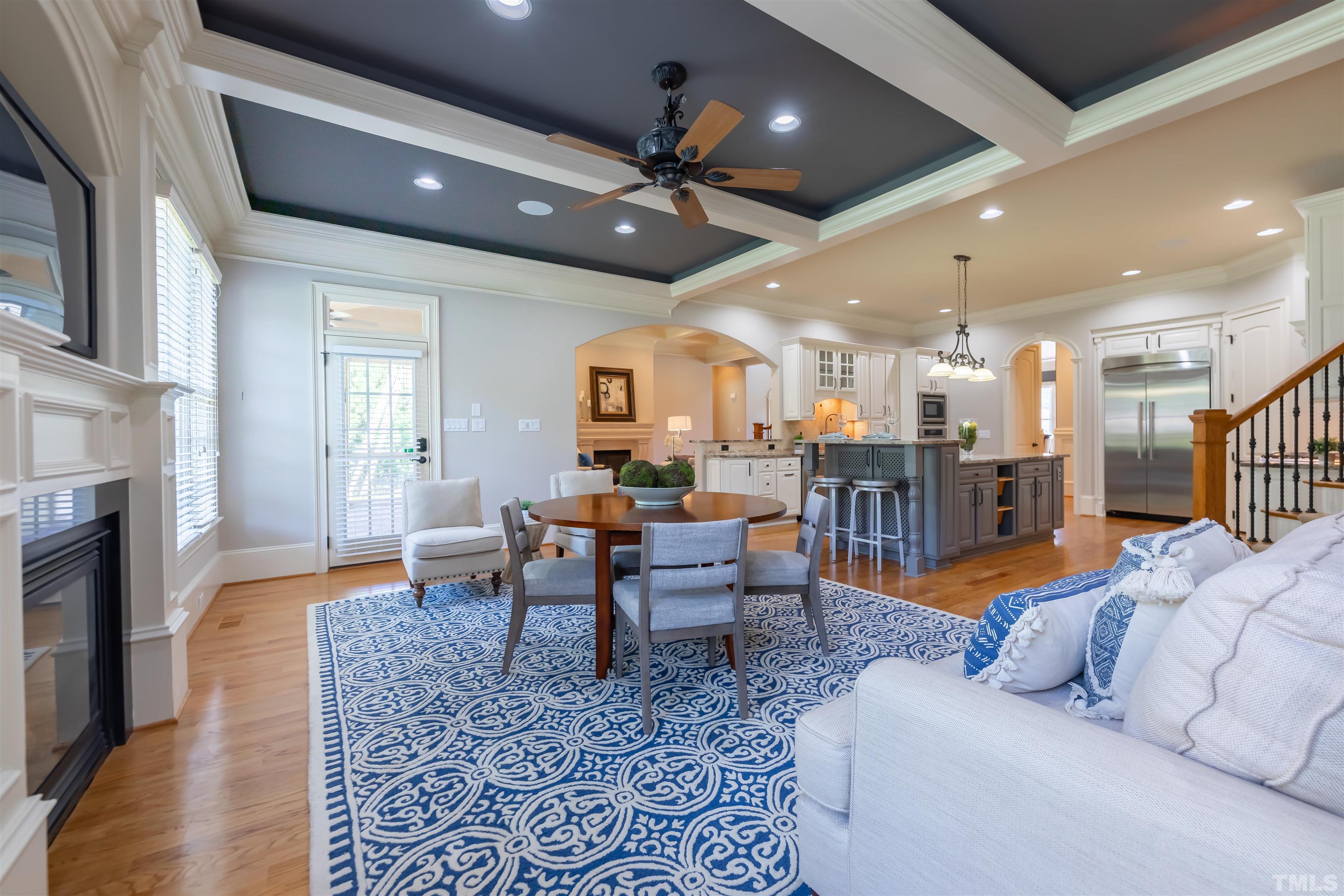 9805 Najma Street Raleigh, NC 27613 - Photo 15 of 29 a living room with furniture kitchen view and a fireplace