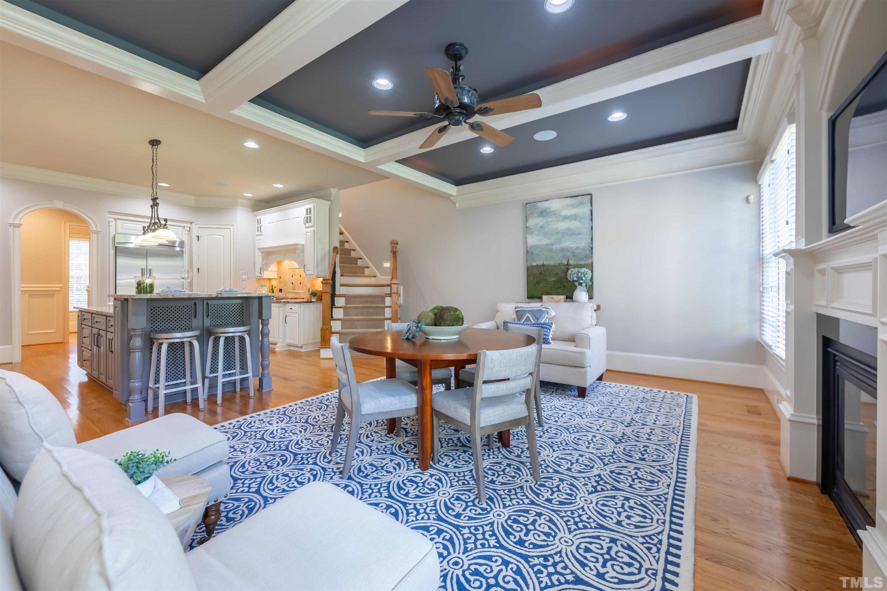 9805 Najma Street Raleigh, NC 27613 - Photo 16 of 29 a living room with furniture a fireplace and a table