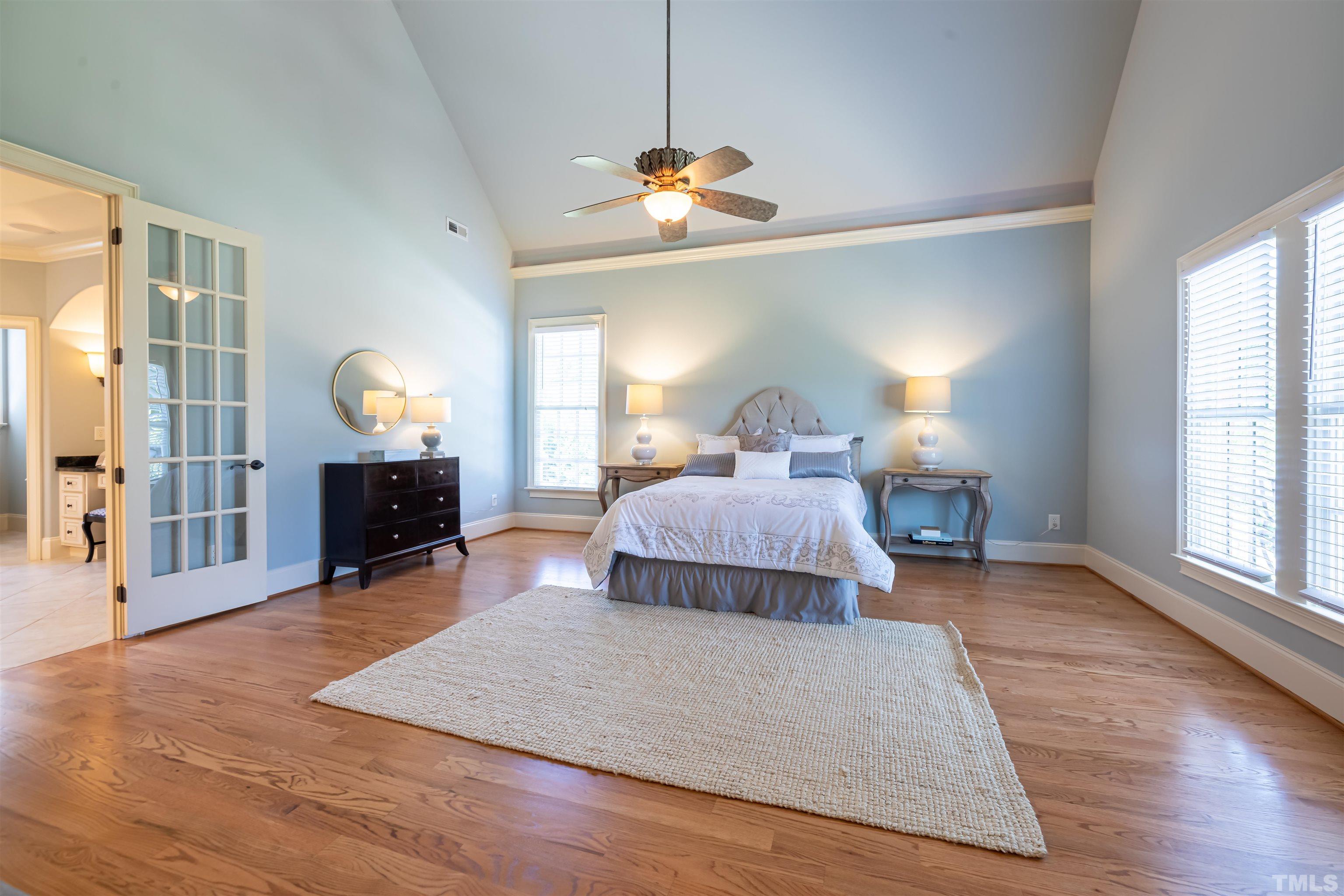 9805 Najma Street Raleigh, NC 27613 - Photo 18 of 29 a bedroom with a bed and wooden floor