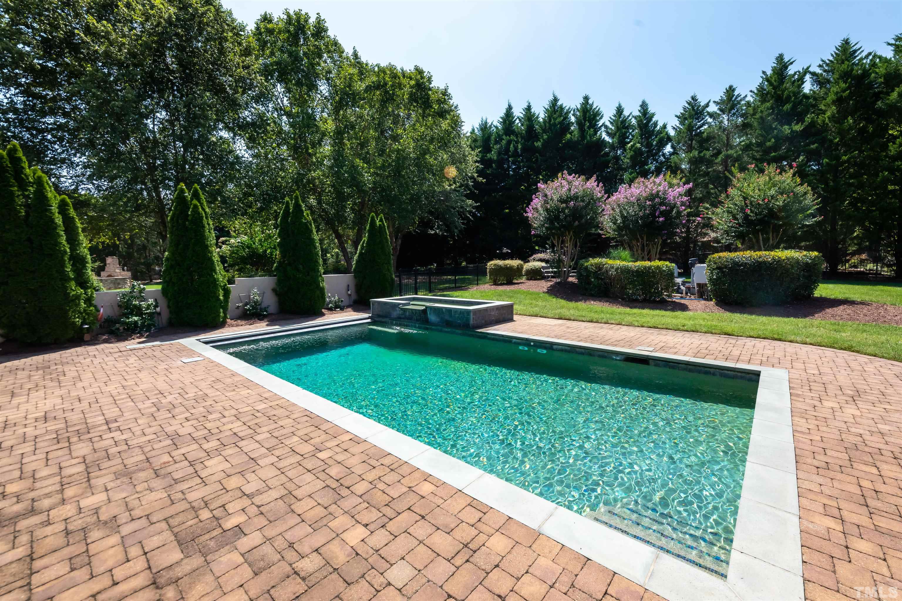 9805 Najma Street Raleigh, NC 27613 - Photo 27 of 29 a view of a house with swimming pool and sitting area