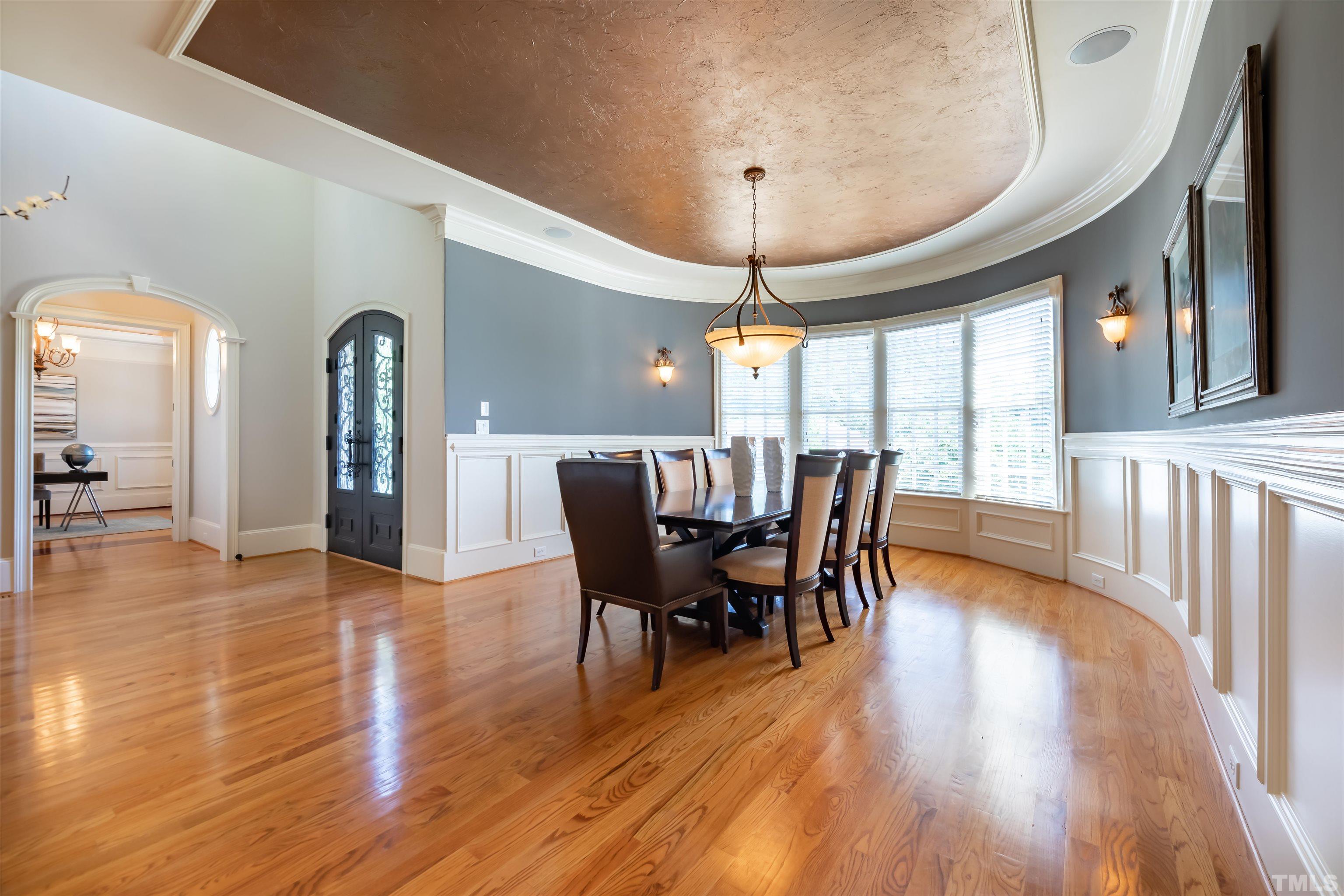 9805 Najma Street Raleigh, NC 27613 - Photo 4 of 29 a view of a dining room with furniture window and wooden floor