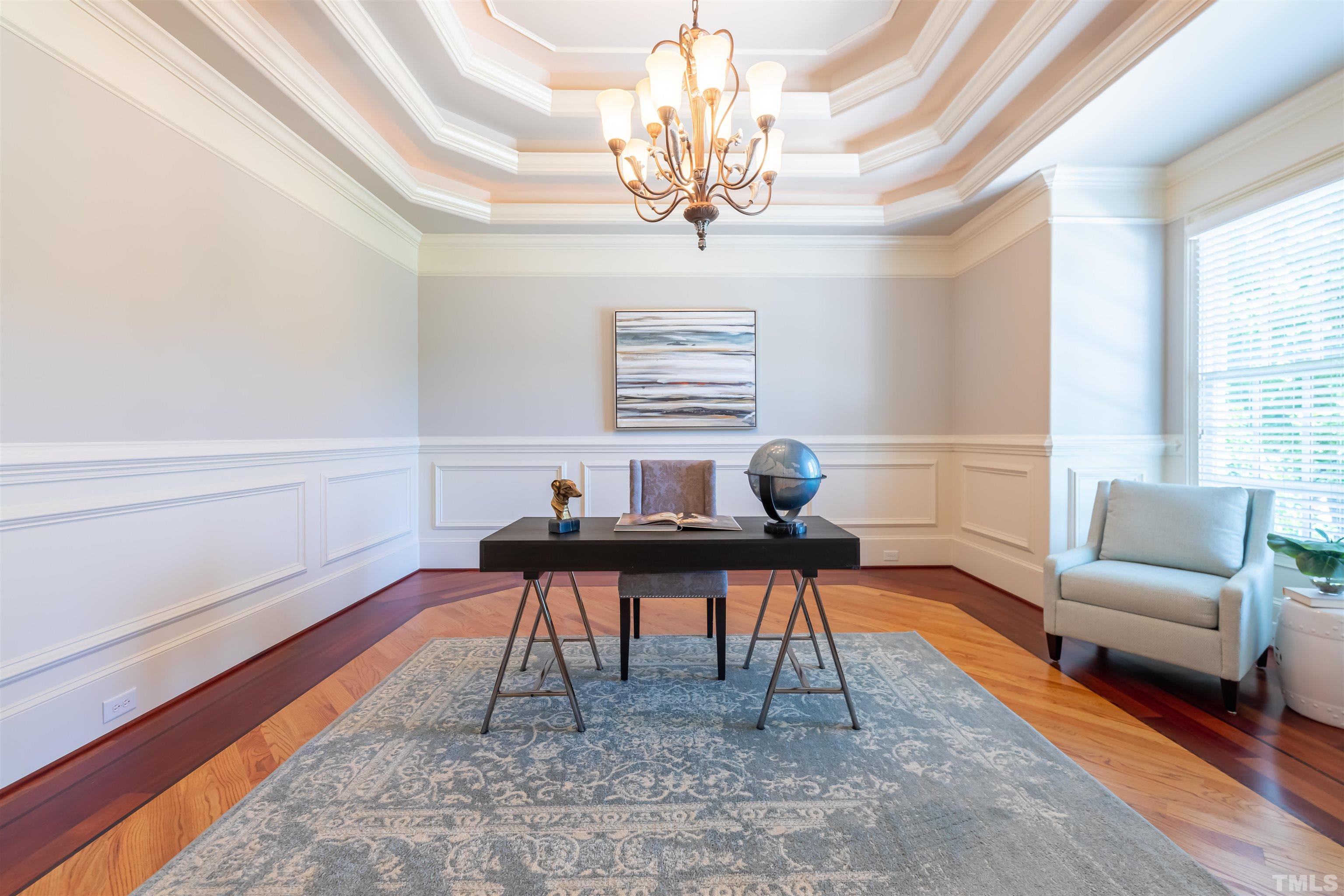9805 Najma Street Raleigh, NC 27613 - Photo 6 of 29 a work room with furniture and a chandelier