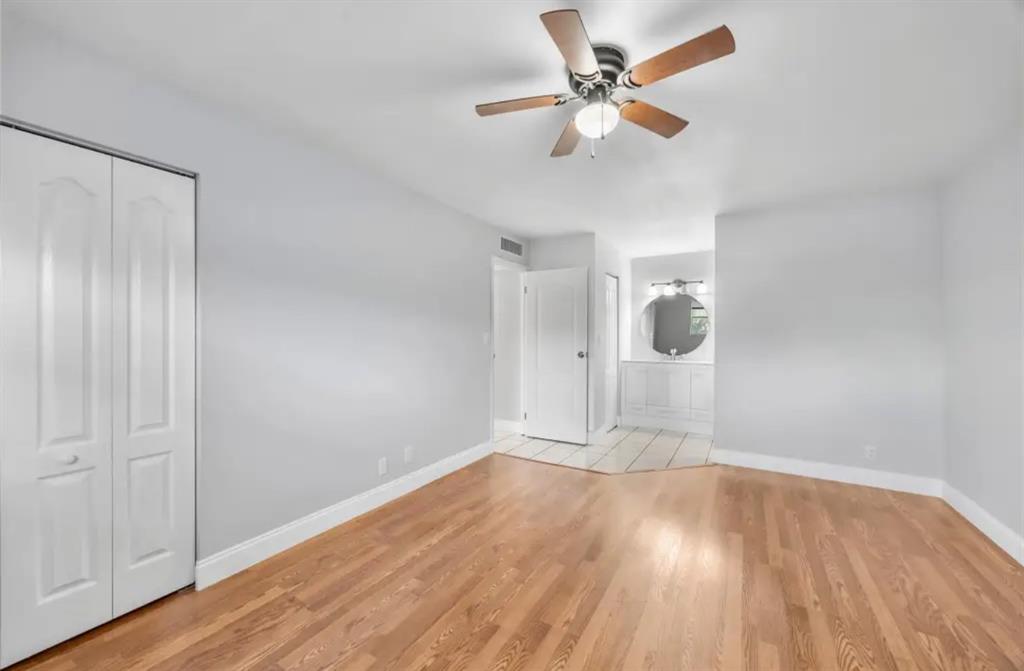 6100 South Falls Cir Drive, Unit 204 Lauderhill, FL 33319 - Photo 13 of 27 an empty room with wooden floor fan and windows