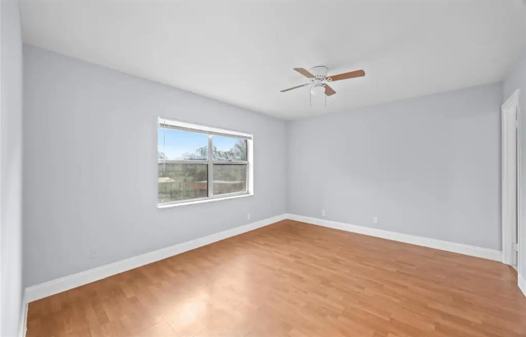 6100 South Falls Cir Drive, Unit 204 Lauderhill, FL 33319 - Photo 14 of 27 an empty room with a window and a ceiling fan