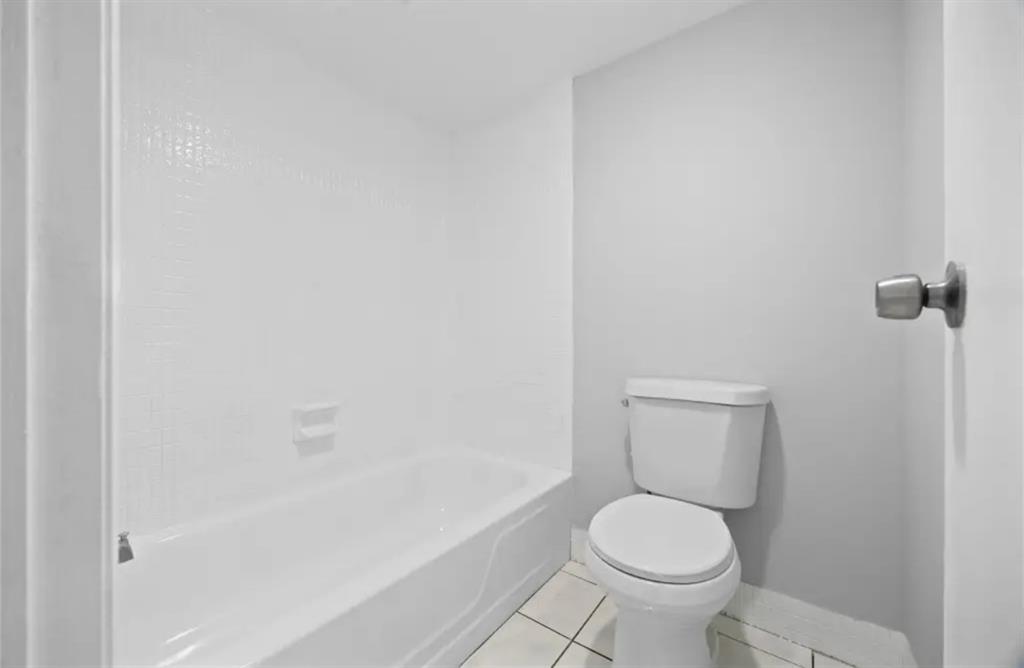 6100 South Falls Cir Drive, Unit 204 Lauderhill, FL 33319 - Photo 17 of 27 a white toilet sitting next to a bath tub