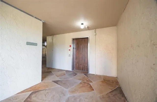 a view of a big room with closet and wooden door