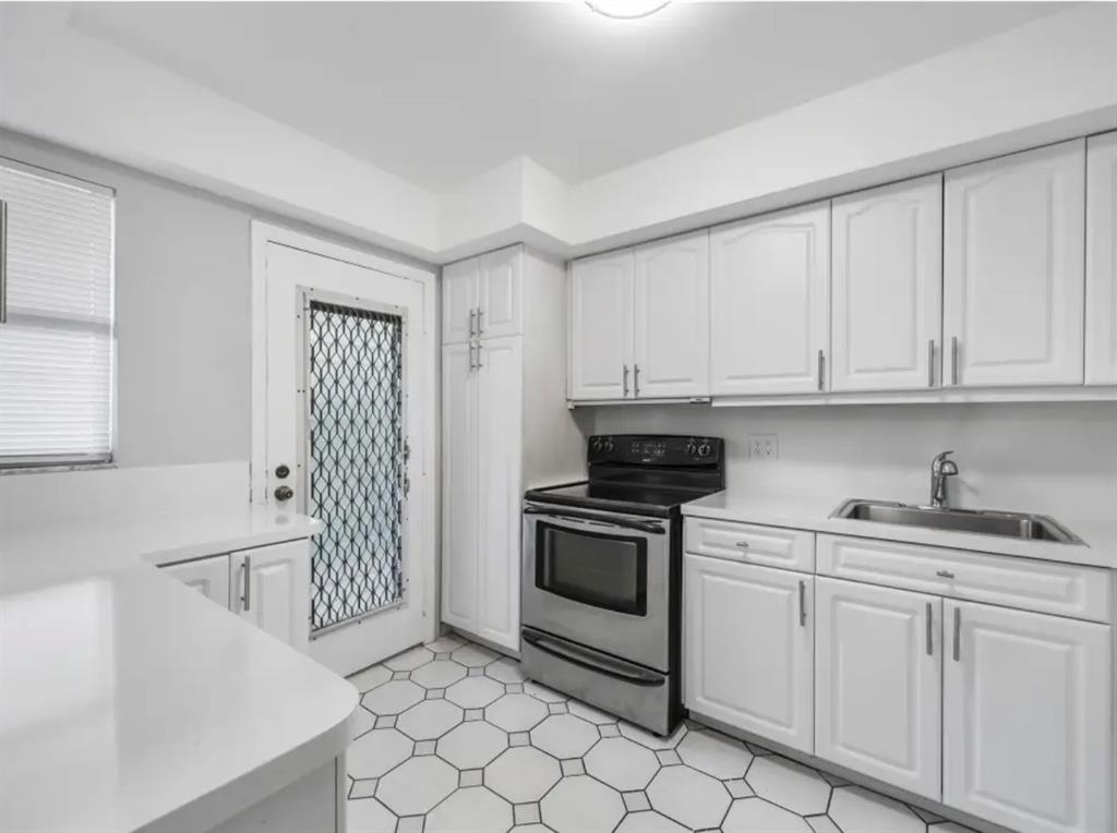 6100 South Falls Cir Drive, Unit 204 Lauderhill, FL 33319 - Photo 4 of 27 a kitchen with white cabinets and appliances