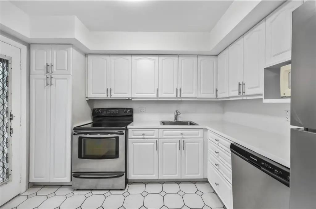 6100 South Falls Cir Drive, Unit 204 Lauderhill, FL 33319 - Photo 6 of 27 a kitchen with white cabinets and white appliances