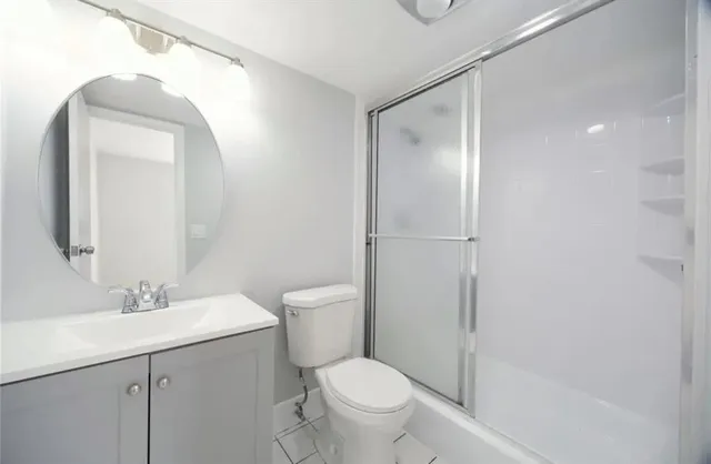 a bathroom with a toilet a sink and a mirror