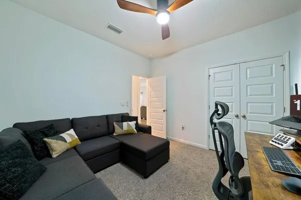 a living room with furniture a couch and a rug