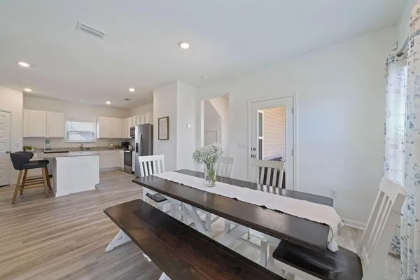 a large white kitchen with a large window