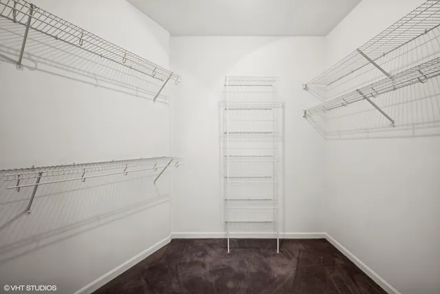 a view of walk in closet with empty racks